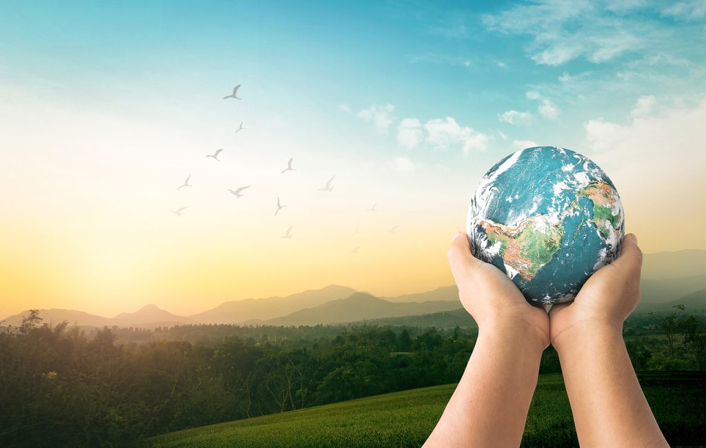 community sharing concept: human hands holding earth global over